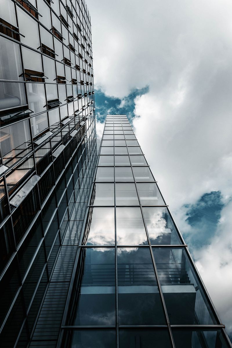 low angle photography of high rise building under cloudy sky